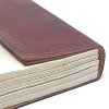 The "Tree of Life" Handmade Leather Journal's wraparound page protector keeps things tidy.