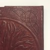Detail View: Craftsmen using dies and traditional hand tools create each unique journal by hand.